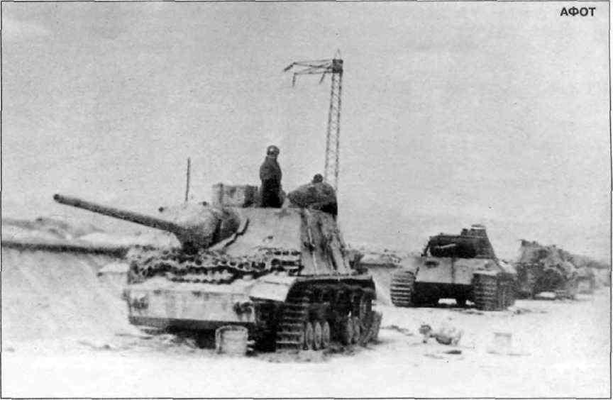 Советские бойцы осматривают колонну немецких танков и САУ, разбитых в районе г. Секешфехервар. Март 1945 г.