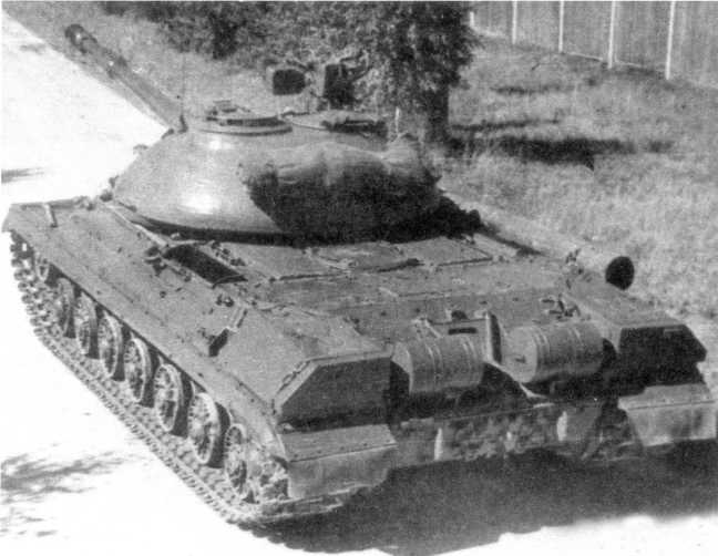 45. Тяжелый танк Т-10М, вид сзади. Хорошо видны наружные топливные баки, дымовые шашки БДШ и укладка брезента на корме башни (АСКМ).