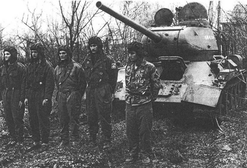 Танк Т-34-85 и его сербский экипаже перед выполнением боевой задачи. Босния, 1995 год. Характерной особенностью югославских "тридцатьчетверок" был крупнокалиберный зенитный пулемет "Браунинг" М2 американского производства, смонтированный прямо на бронеколпаках вентиляторов.