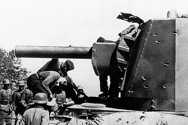 Немцы у подбитого КВ-2 из состава 2-й танковой дивизии 3-го мехкорпуса РККА. Машина была оставлена экипажем у литовского местечка Шаукотас. Июнь 1941 года. На башне танка видны многочисленные следы от попаданий 37-мм бронебойных снарядов (ЯМ).