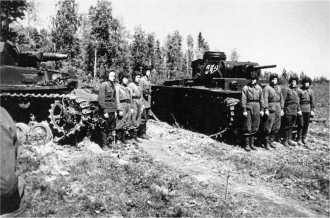 Экипажи 107-го отдельного танкового батальона перед выходом на боевое задание. Волховский фронт, июль 1942 года. На фото — Pz.IV Ausf.F1 (слева) и Pz.III Ausf.J (справа). Танки выкрашены в зеленый цвет.