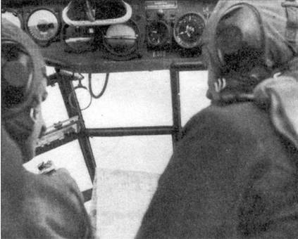 1-й лейтенант Гомбош и наблюдатель из его экипажа определяют свое местоположение в полете путем сличения карты с подстилающей местностью. Обратите внимание на кольцо, закрепленной перед Гомбошом на уровне глаз летчика — это прицел установленных в центроплане пулеметов MG-15. Хорошо видны пилотажно-навигационные приборы, установленные на верхней приборной панели.