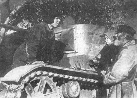 Член экипажа танка Т-26 обр. 1933 г. беседует с сельскими жителями ЗапОВО, 1940 г.