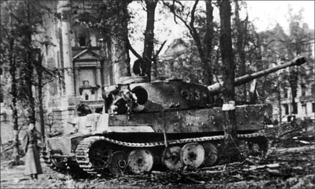 Этот «Тигр», подбитый советскими войсками в центре Берлина, принадлежал к составу <a href='https://arsenal-info.ru/b/book/1627328415/38' target='_self'>танковой дивизии</a> «Мюнхеберг». Май 1945 года.